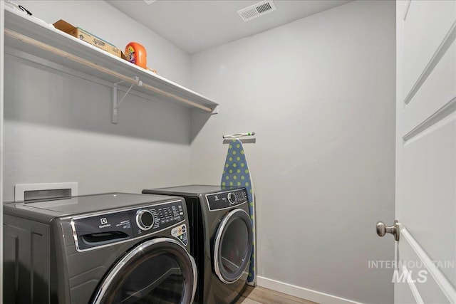4953 W Apgar St, Meridian, ID 83646 - laundry area with separate washer and dryer, baseboards, and light wood-style flooring
