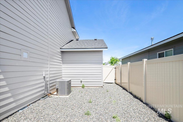 4953 W Apgar St, Meridian, ID 83646 - view of home's exterior featuring central air condition unit, roof with shingles, and a gate