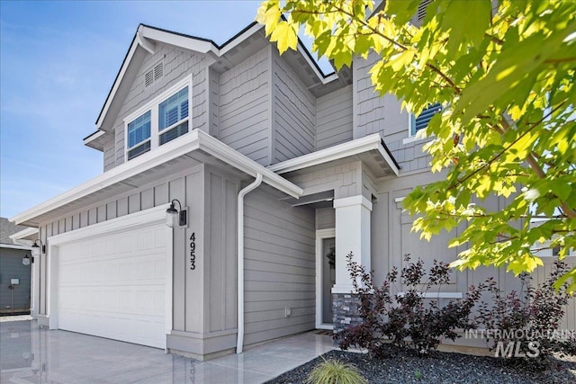 4953 W Apgar St, Meridian, ID 83646 - view of side of home featuring an attached garage, board and batten siding, and driveway