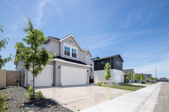 4953 W Apgar St, Meridian, ID 83646 - view of front of home featuring board and batten siding, a garage, driveway, and a residential view