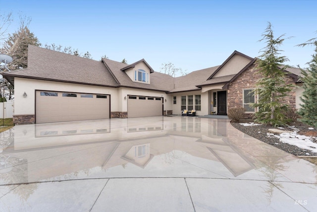 view of front facade with stone siding, concrete driveway, an attached garage, and stucco siding