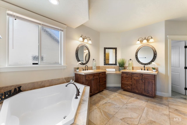 bathroom featuring two vanities, a sink, and a bath