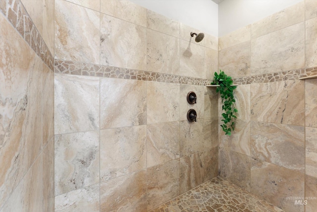 full bath with a tile shower