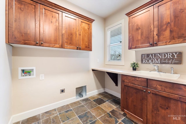 laundry room with cabinet space, baseboards, hookup for a washing machine, hookup for an electric dryer, and a sink