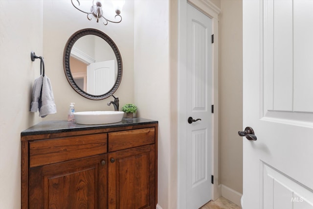 bathroom featuring baseboards, a closet, and vanity