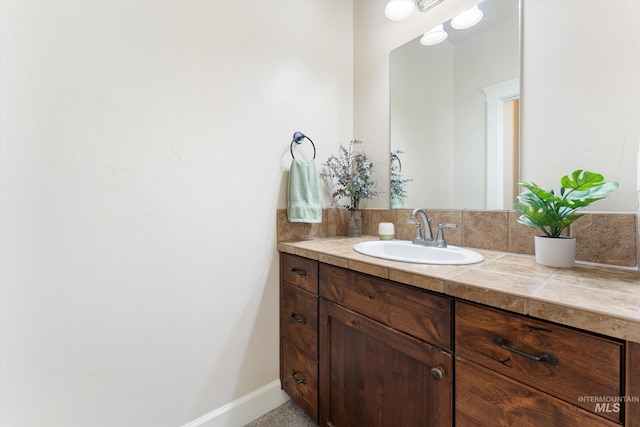 bathroom with vanity and baseboards