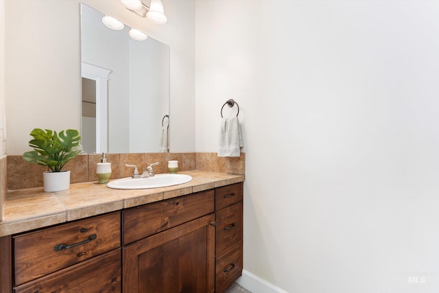 bathroom with baseboards and vanity