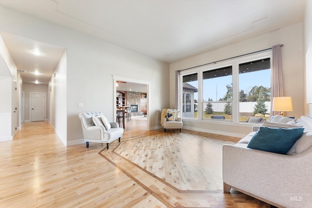 sitting room featuring visible vents, baseboards, and wood finished floors