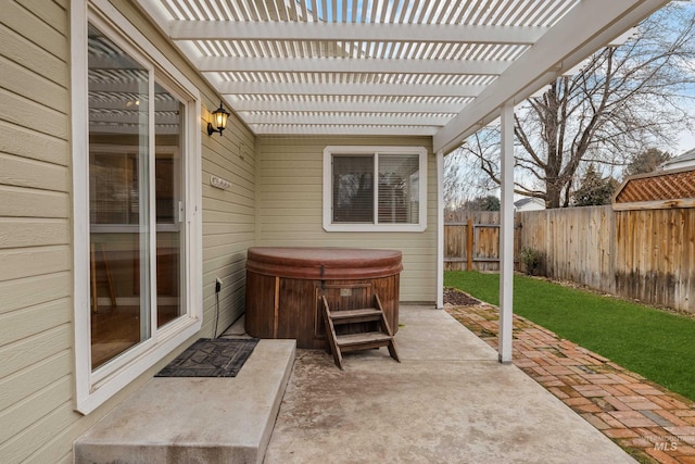 view of patio featuring a fenced backyard, a hot tub, and a pergola