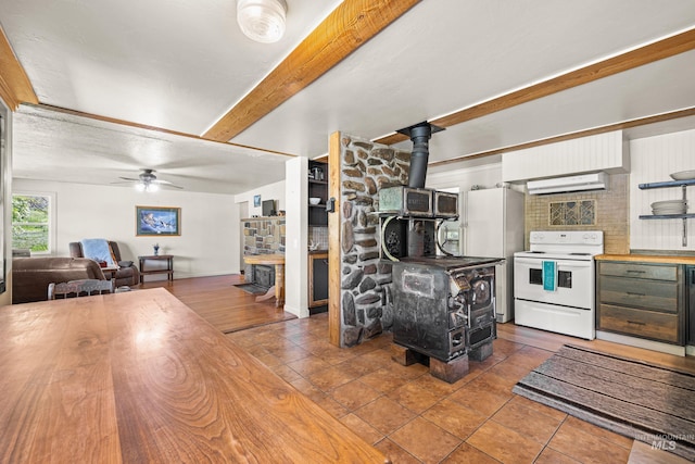 255 Seven U Ranch Rd, Lucile, ID 83542 - kitchen with white appliances, a wood stove, butcher block counters, ceiling fan, and beamed ceiling