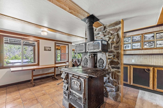 255 Seven U Ranch Rd, Lucile, ID 83542 - office area featuring baseboards, light tile patterned floors, and a wood stove