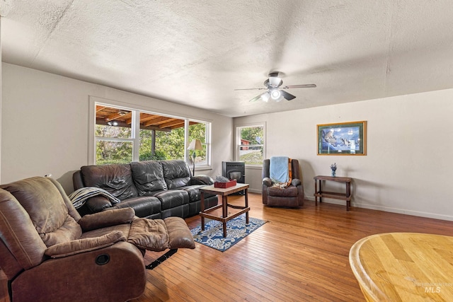 255 Seven U Ranch Rd, Lucile, ID 83542 - living room with light wood-style flooring, ceiling fan, a textured ceiling, and baseboards