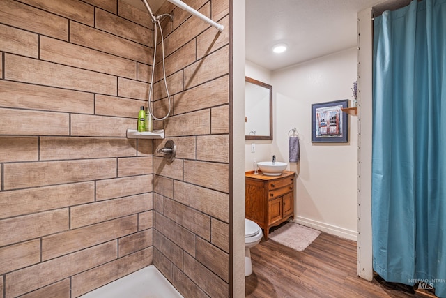 255 Seven U Ranch Rd, Lucile, ID 83542 - bathroom featuring vanity, a tile shower, wood finished floors, baseboards, and toilet
