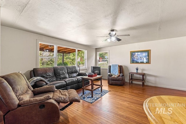 255 Seven U Ranch Rd, Lucile, ID 83542 - living room with light wood-type flooring, a ceiling fan, a textured ceiling, and baseboards