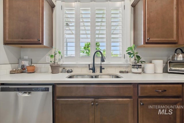 5707 W Elk Trail St Unit 630, Boise, ID 83714 - kitchen featuring stainless steel dishwasher, a sink, light countertops, and brown cabinets