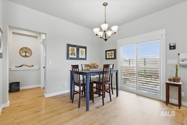 5707 W Elk Trail St Unit 630, Boise, ID 83714 - dining area featuring a chandelier, light wood-style floors, and baseboards