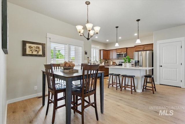 5707 W Elk Trail St Unit 630, Boise, ID 83714 - dining room with light wood-type flooring, a chandelier, baseboards, and recessed lighting