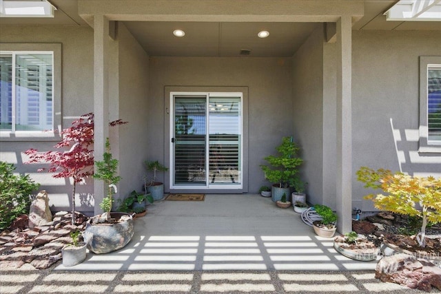 5707 W Elk Trail St Unit 630, Boise, ID 83714 - view of exterior entry with stucco siding and a patio area