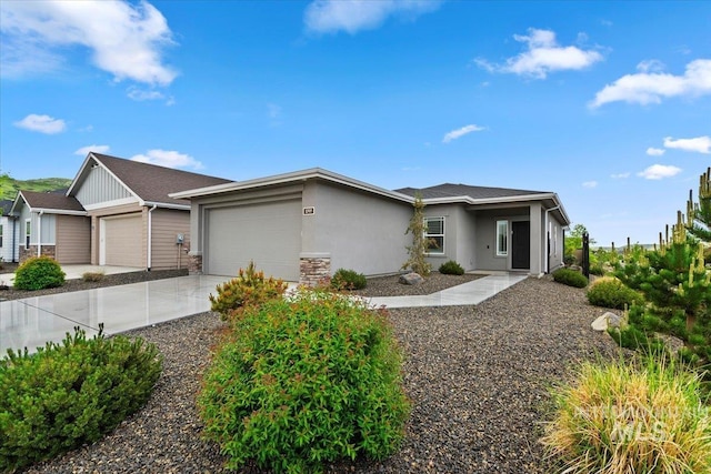 5707 W Elk Trail St Unit 630, Boise, ID 83714 - view of front of property with a garage, stucco siding, and driveway