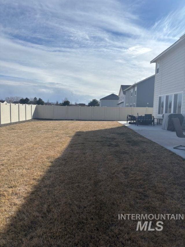 view of yard with a patio and a fenced backyard