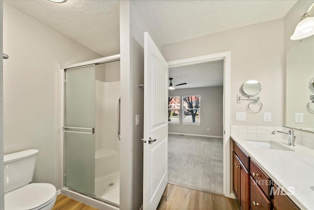 bathroom with a shower with door, vanity, and hardwood / wood-style floors