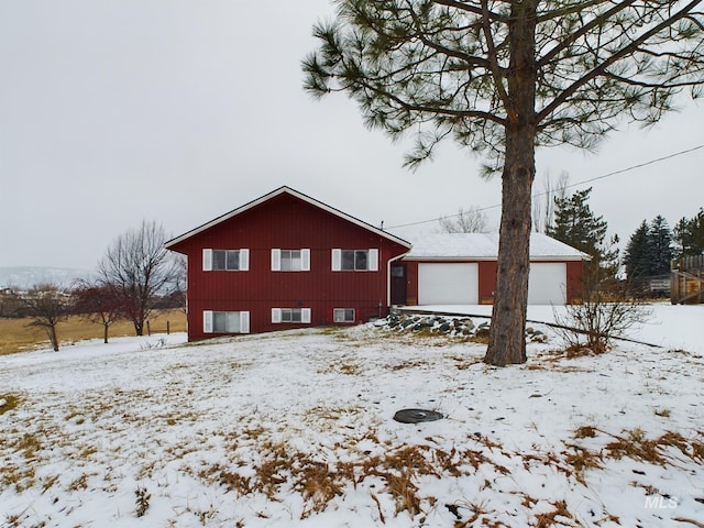 view of snow covered exterior featuring a garage