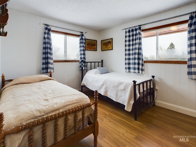 bedroom featuring hardwood / wood-style floors and a textured ceiling