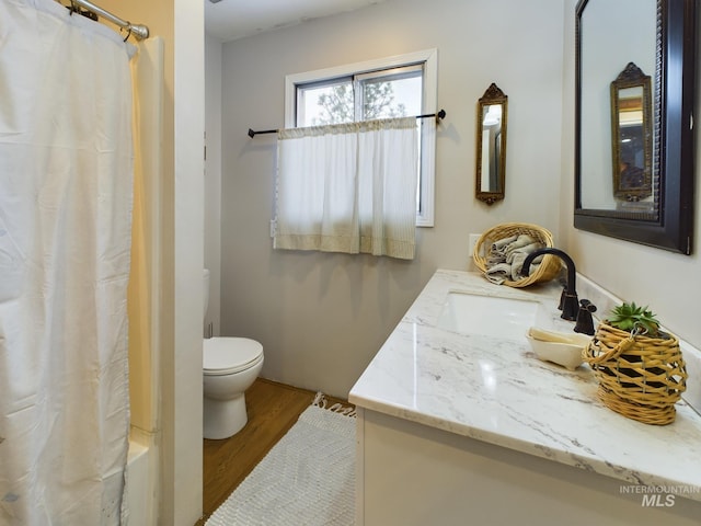 bathroom featuring vanity, hardwood / wood-style flooring, and toilet