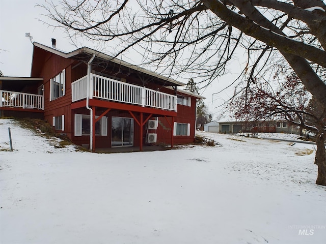 view of snow covered back of property