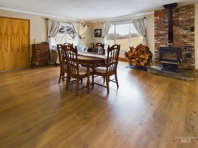 dining room featuring hardwood / wood-style flooring, ornamental molding, and plenty of natural light