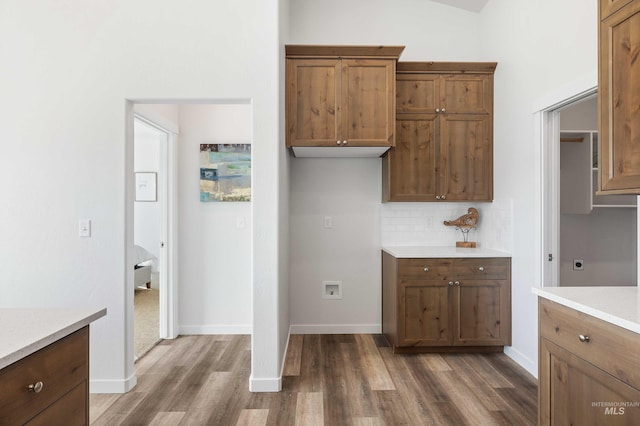 205 W 13th Ave, Jerome, ID 83338 - kitchen with dark wood-type flooring, light countertops, tasteful backsplash, and brown cabinets