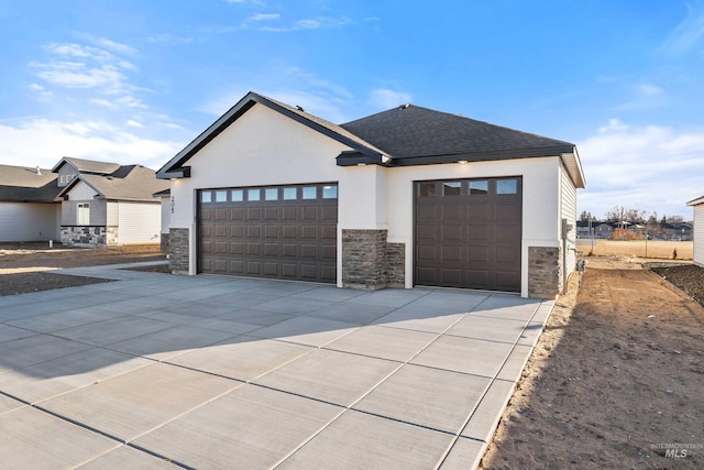 205 W 13th Ave, Jerome, ID 83338 - view of front of home with stone siding, stucco siding, driveway, and a garage