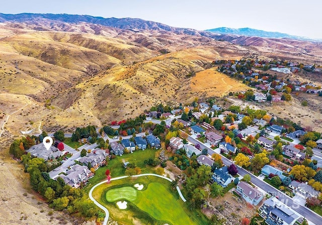 drone / aerial view with a residential view, a mountain view, and golf course view