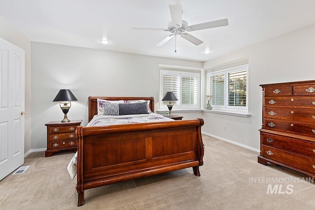 bedroom featuring light carpet, baseboards, visible vents, and ceiling fan