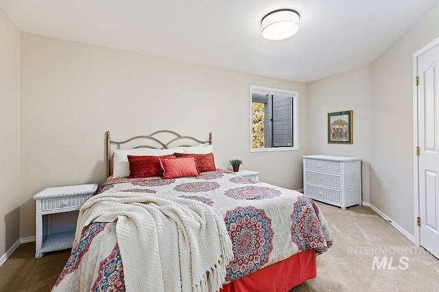 carpeted bedroom featuring baseboards