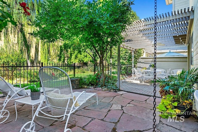 view of patio with fence and a pergola