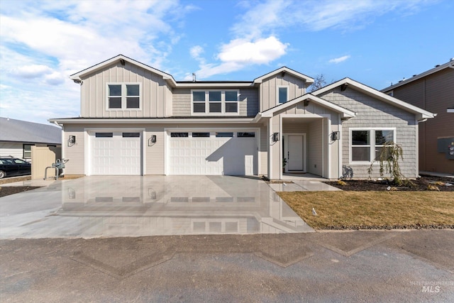 view of front of home with driveway, an attached garage, board and batten siding, and a front yard