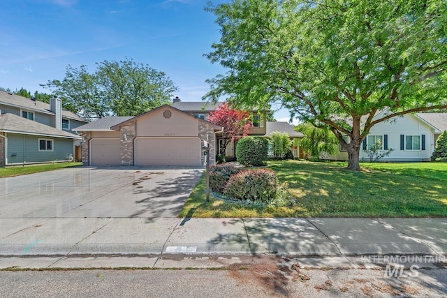 10397 W Hinsdale Ct, Boise, ID 83704 - view of front of home with an attached garage, a front yard, driveway, and brick siding