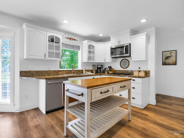 248 N Palmetto Dr, Eagle, ID 83616 - kitchen featuring stainless steel appliances, glass insert cabinets, white cabinetry, recessed lighting, and wood finished floors