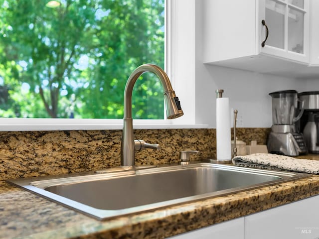 248 N Palmetto Dr, Eagle, ID 83616 - kitchen view of white cabinetry, glass insert cabinets, and light stone countertops