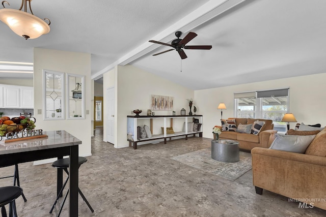 living area with vaulted ceiling with beams and ceiling fan