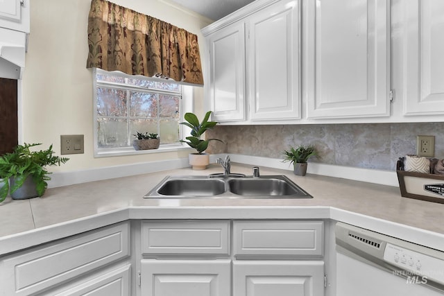 kitchen with light countertops, dishwasher, white cabinetry, and a sink