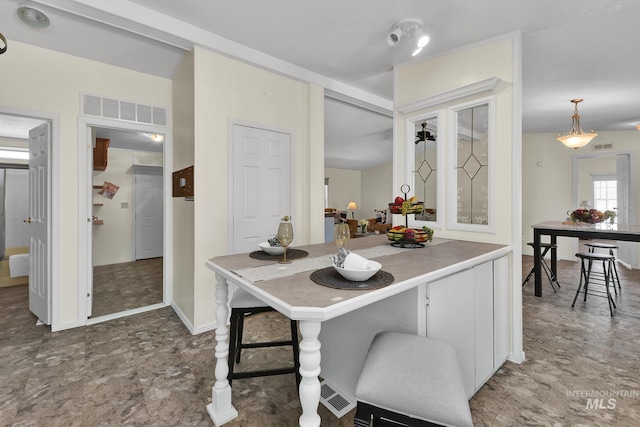 kitchen featuring white cabinetry and visible vents