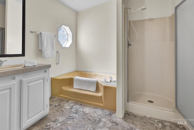 bathroom with a bath, vanity, and a shower stall
