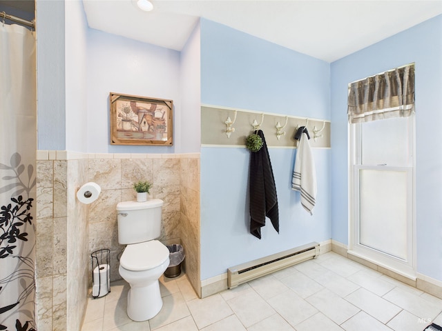 1929 S 2350 E, Malta, ID 83342 - bathroom featuring baseboard heating, tile walls, toilet, tile patterned flooring, and wainscoting