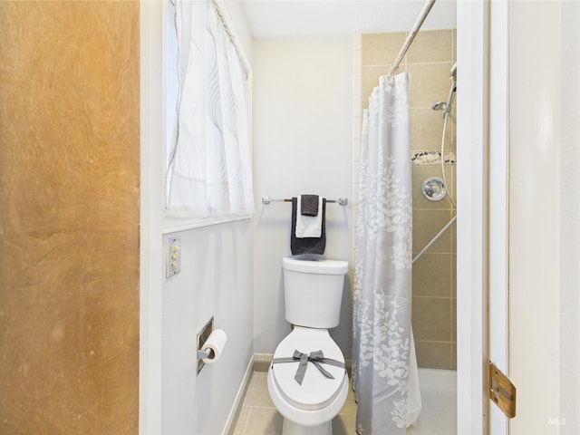 1929 S 2350 E, Malta, ID 83342 - bathroom featuring toilet, tiled shower, baseboards, and tile patterned flooring