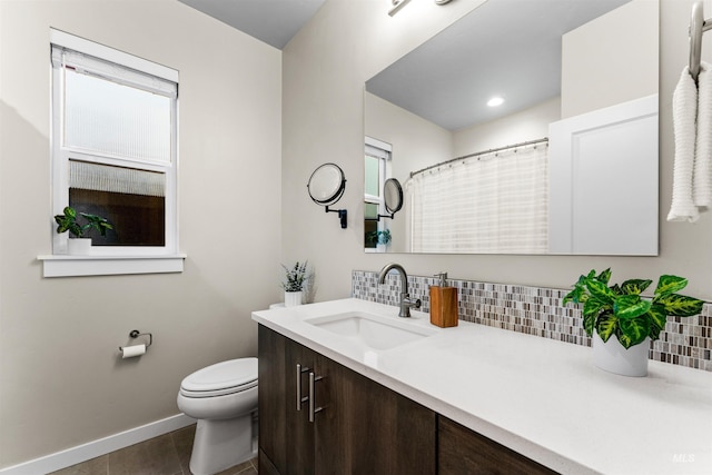 bathroom with decorative backsplash, vanity, toilet, and tile patterned flooring