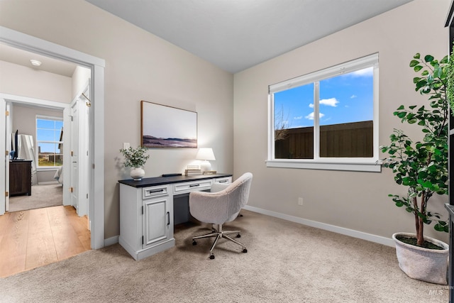 home office with light hardwood / wood-style flooring