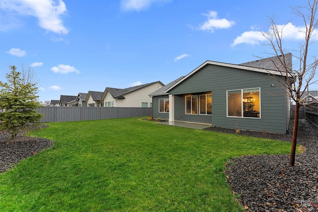 rear view of property featuring a lawn