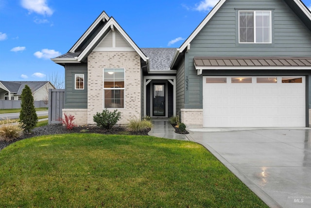 view of front of house with a front yard and a garage